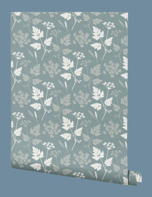 Roll of wallpaper with a cow parsley pattern on a teal background